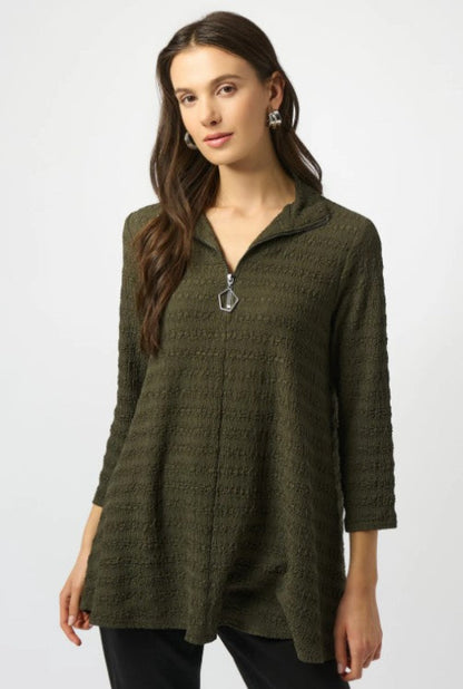 Woman wearing a green textured sweater on a white background