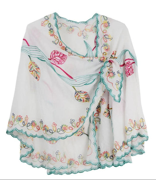 White cape with colorful floral embroidery on a white background