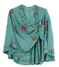 Turquoise cape with colorful floral embroidery on a white background
